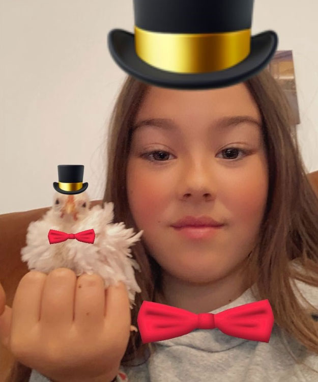 My grandaughter with a Frizzle Serama Rooster chick - playing around with phone filters